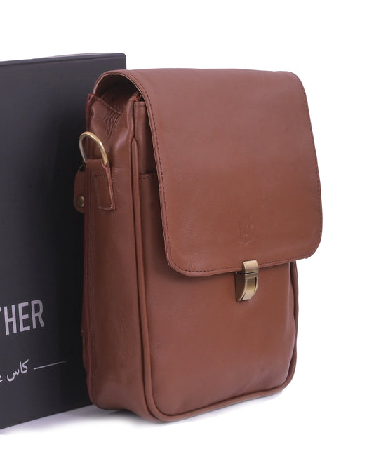 Brown leather bag with gold buckle on a white background